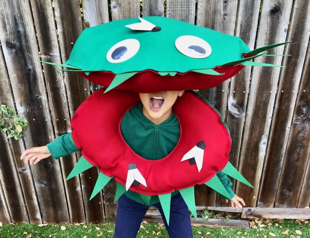Kid wearing homemade Venus flytrap costume